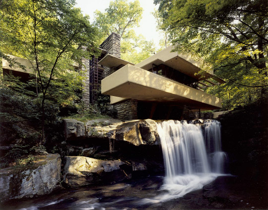 [Fallingwater main house from low angle near waterfall]